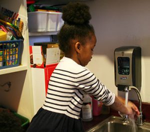 picture of kindergarten student at sink washing hands
