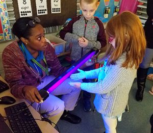 picture of student placing hands under black light
