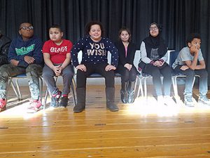 picture of students waiting on stage for spelling bee to begin