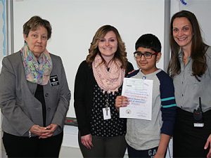 picture of essay winner standing with teacher, school principal and Elks representative