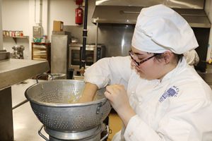 picture of WHS student working in Career and Technical School culinary prep classroom