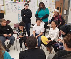 picture of students seated in a circle talking