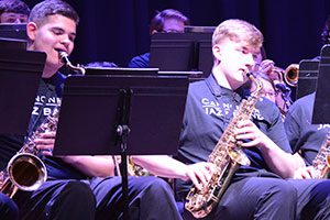 picture of two students on stage playing saxophone