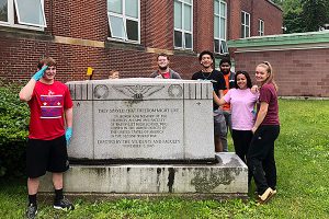 picture of students standing next to clean World War II memorial