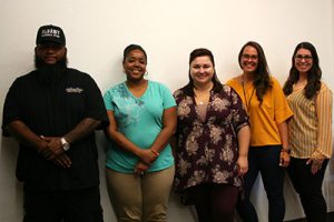 new teachers and staff stand in the conference room during orientation