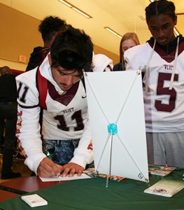 picture of students filling out paperwork at College Caravan