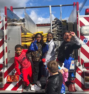 picture of students on back of fire truck