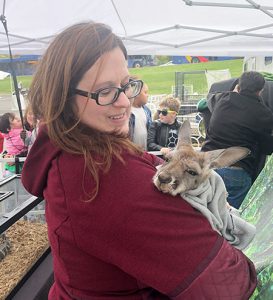 picture of teacher holding baby kangaroo