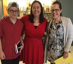 picture of author with arms around Watervliet student and teacher