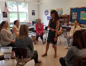 picture of teachers seated in circle engaged in restorative practice activity