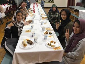 picture of students seated at Thanksgiving table