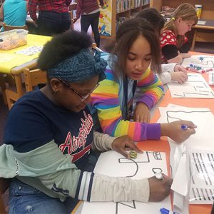 picture of students coding a path for ozobots to follow