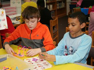 picture of students using makerspace equipment to build objects