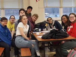 picture of junior varsity and varsity Mastermind teams seated in a group smiling at the camera 