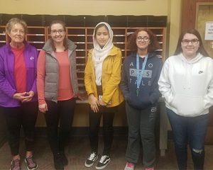 picture of essay winners standing with teacher and Elks rep in high school main office