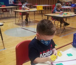 picture of prekindergarten student playing with Lego-type toy