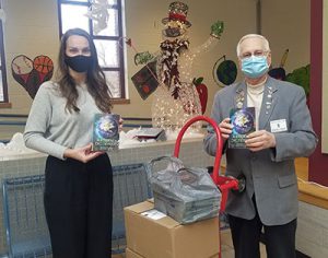 picture of Watervliet Elks member presenting dictionaries to WES Principal