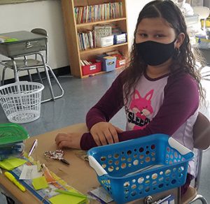 picture of student in pajamas seated at desk