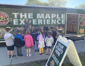 picture of students standing in front of the Maple Experience trailer