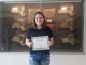 picture of student holding scholarship award certificate