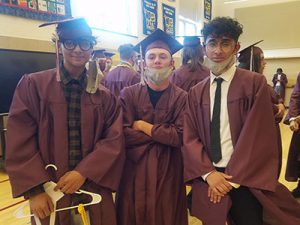 picture of three graduates standing together