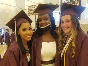 picture of three graduates standing together