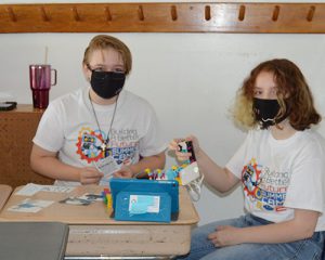 picture of two students at desk working on Lego robot