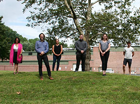 picture of six (6) new teachers and staff standing outside WES playground area