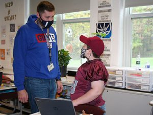 picture of teacher in the classroom talking with a student