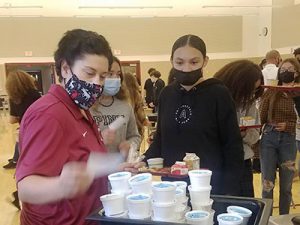 picture of assistant principal handing out ice cream to a student waiting in line