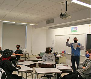 picture of Masterminds team adviser and students during practice before first competition