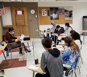 picture of Watervliet Mastermind team competing with another team in a classroom at Niskayuna High School