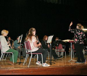 picture of student musicians practicing instruments on stage in Watervliet High School auditorium