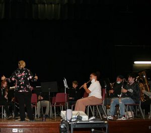 picture of student musicians practicing instruments on stage in Watervliet High School auditorium