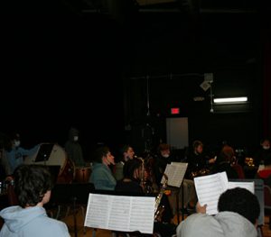 picture of student musicians practicing instruments on stage in Watervliet High School auditorium