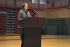 Assistant Superintendent standing at podium speaking to audeince.