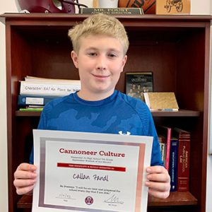 Grade 7 Cannoneer Culture "Be Present" Student of the Month for October 2022 holding award certificate and smiling at camera.
