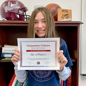 Grade 8 Cannoneer Culture "Be Proud" Student of the Month for October 2022 holding award certificate and smiling at camera.