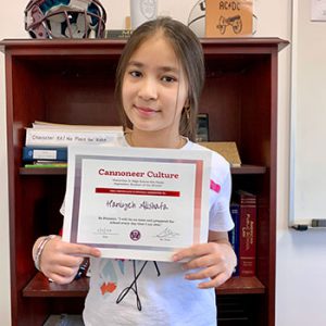 Grade 6 Cannoneer Culture "Be Present" Student of the Month for October 2022 holding award certificate and smiling at camera.