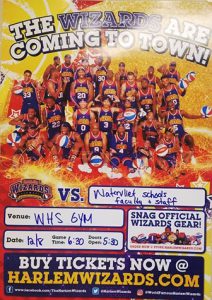 Harlem Wizards poster promoting December 8 game at Watervliet Junior Senior High School. Poster has game information and features image of basketball team in the background.