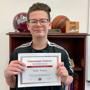 Grade 7 Cannoneer Culture "Be Positive" Student of the Month for October 2022 holding award certificate and smiling at camera.