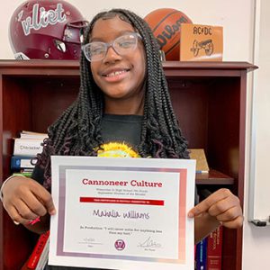 Grade 7 Cannoneer Culture "Be Productive" Student of the Month for October 2022 holding award certificate and smiling at camera.