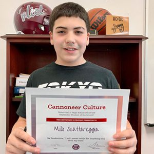 Grade 8 Cannoneer Culture "Be Productive" Student of the Month for October 2022 holding award certificate and smiling at camera.