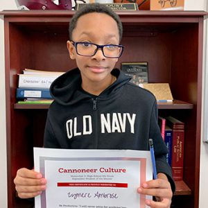 Grade 6 Cannoneer Culture "Be Productive" Student of the Month for October 2022 holding award certificate and smiling at camera.