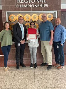 Rensselaer Medal winner holds certificate while standing with high school principal, superintendent of schools, science teacher and guidance counselor after award presentation