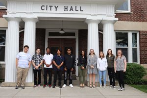 Ten high school seniors stand together at the entrance to Watervliet City Hall at the start of the Youth Day job shadow event