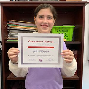 Grade 6 Be Productive Student of the Month for September holds award certificate