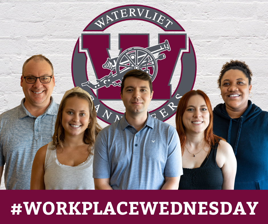 new staff members in front of brick wall with Watervliet logo... text on-screen: #WorkplaceWednesday