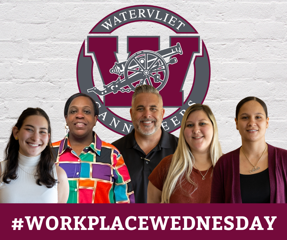 new staff members in front of brick wall with Watervliet logo... text on-screen: #WorkplaceWednesday