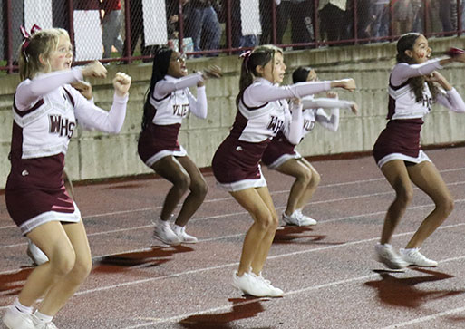 Watervliet cheerleaders in the midst of performing a routine during a football game